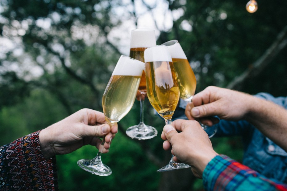 four hands cheers glasses filled with mead from Heidrun Meadery in Point Reyes