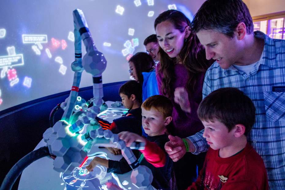 a family looks at an exhibit at Tech Museum of Innovation, San Jose, California, picture