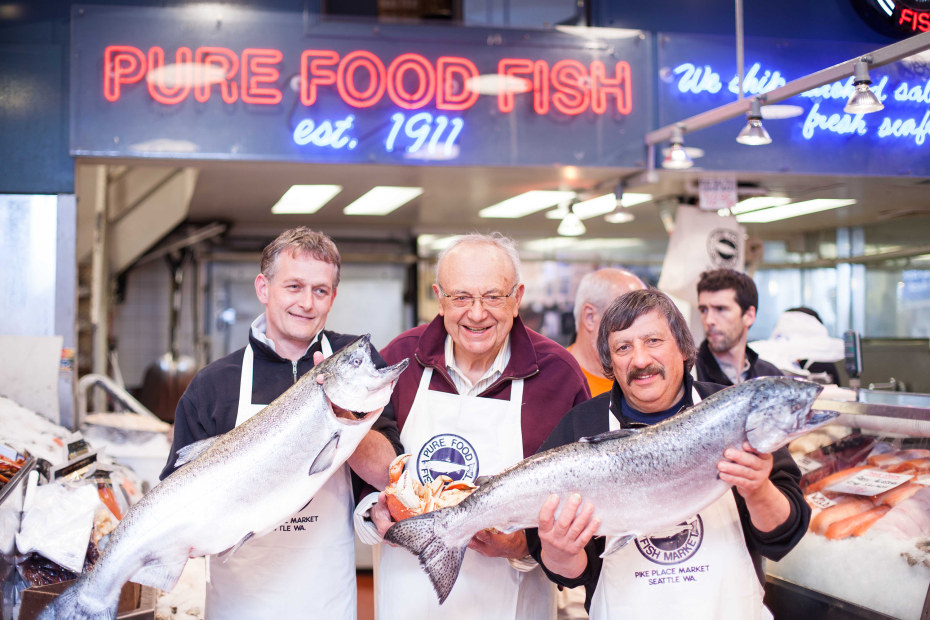 Pure Food fishmongers Sean Sr., Sol "Solly" Amon, and Harry holding fresh salmon at Pike Place Market in Seattle, Washington, picture