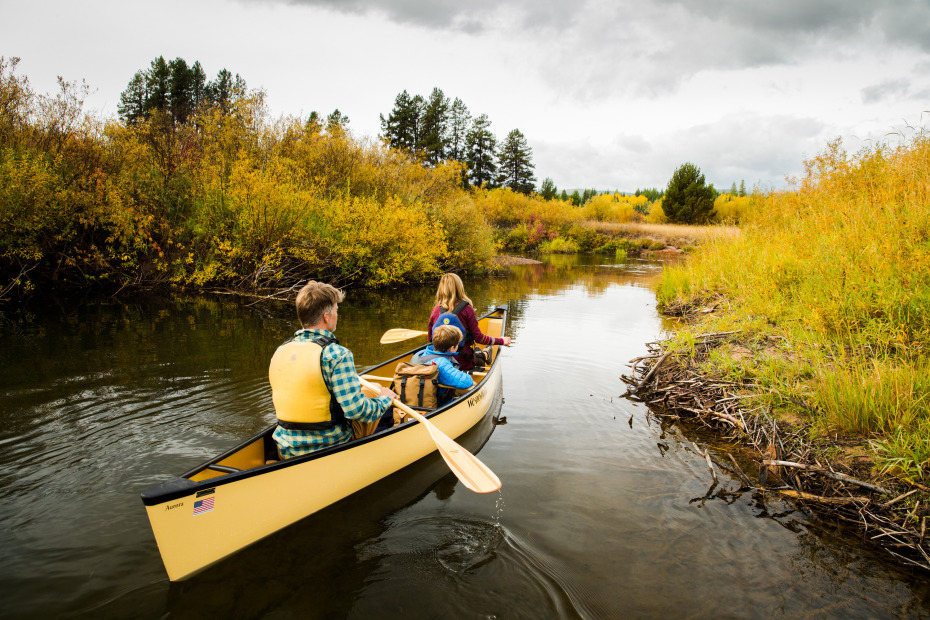 photo of a family paddling in a canoe on Seeley Lake