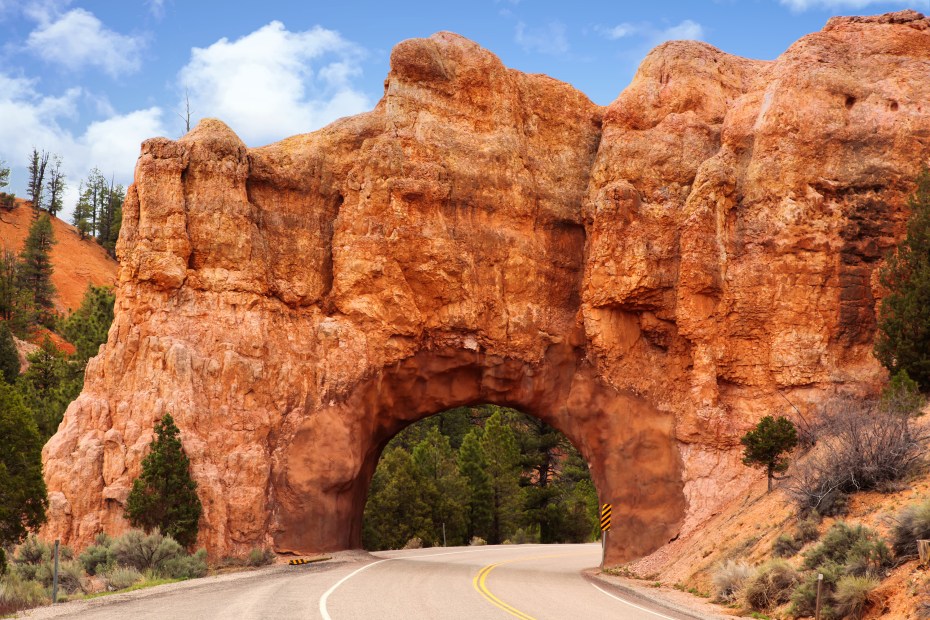 Utah's Highway 12 cuts through a red rock tunnel, image