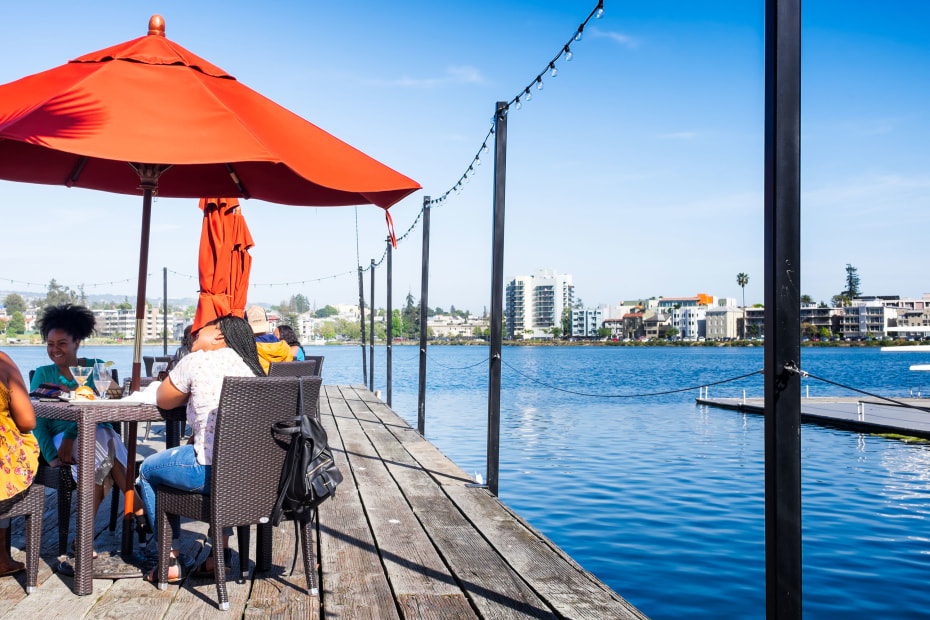 Group of women dining and drinking during the afternoon happy hour at a waterfront restaurant at Lake Merritt, picture