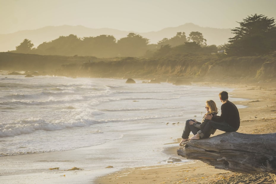 A couple sits on Moonstone Beach at sunset, Cambria, California, image