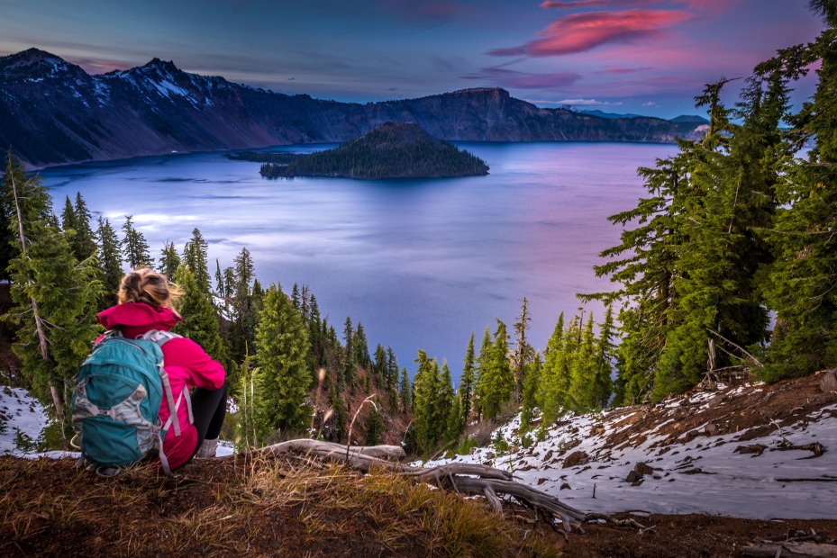 backpacker looking at Crater Lake during sunset, picture