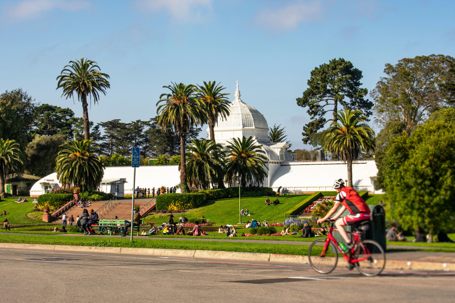 A cyclist rides past The Conservatory of Flowers in San Francisco's Golden Gate Park.