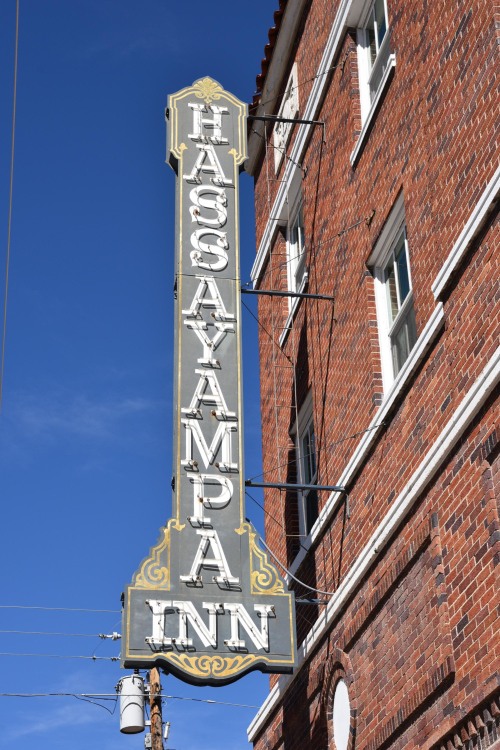 Hassayampa Inn sign on a brick building in Prescott, Arizona.