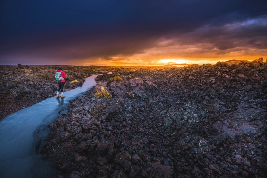 A woman walks through the lava fields at Craters of the Moon, Idaho