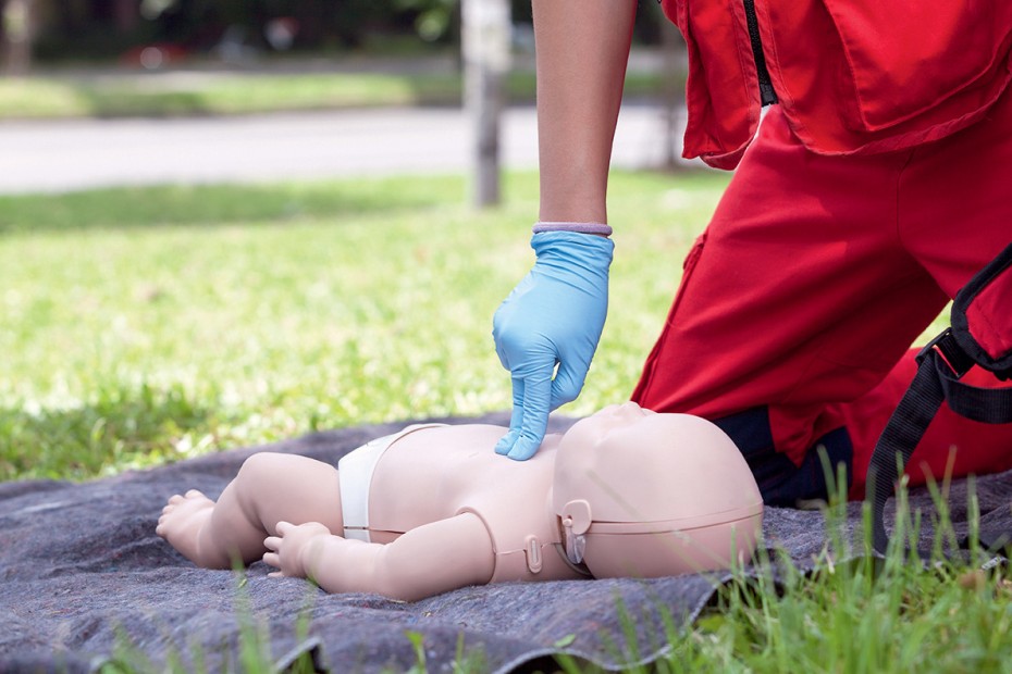 A student learns how to do CPR on an infant.