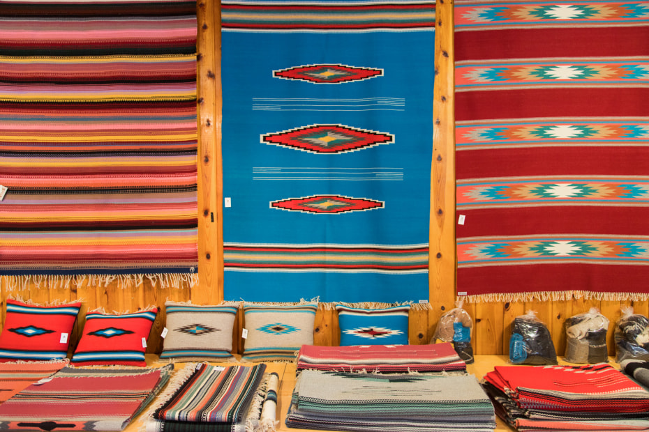 weaving arts hang from the walls at Ortegas Weaving Shop in Chimayo, New Mexico