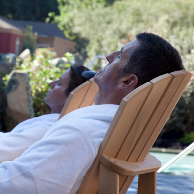 Couple relaxes in Adirondack chairs at Refuge Carmel Valley, image