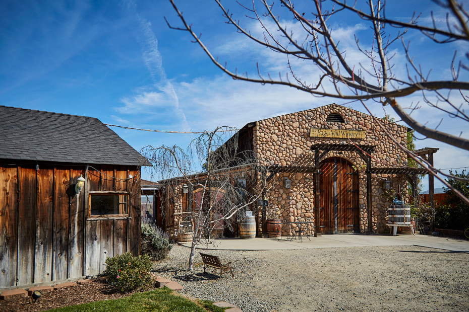 the stone facade of page mill winery in livermore, california, with a blue sky in the background