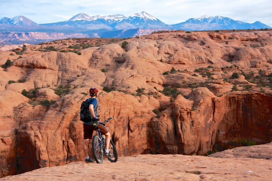 A biker takes a break on the Slickrock mountain bike trail in Moab, Utah, image