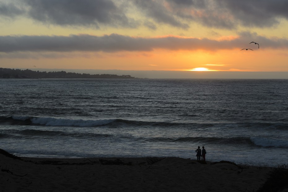 the sun sets behind the cool waters of Monterey Bay, image