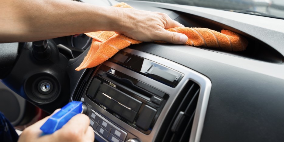 picture of male hands wiping down a dashboard