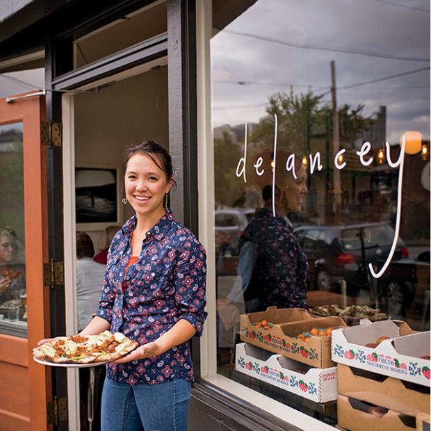 woman stands outside of Delancey in Ballard, picture