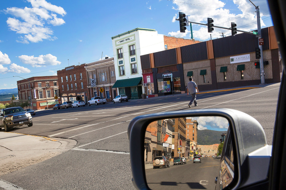 picture of a view of a downtown street of butte, montana from the driver's side of a car