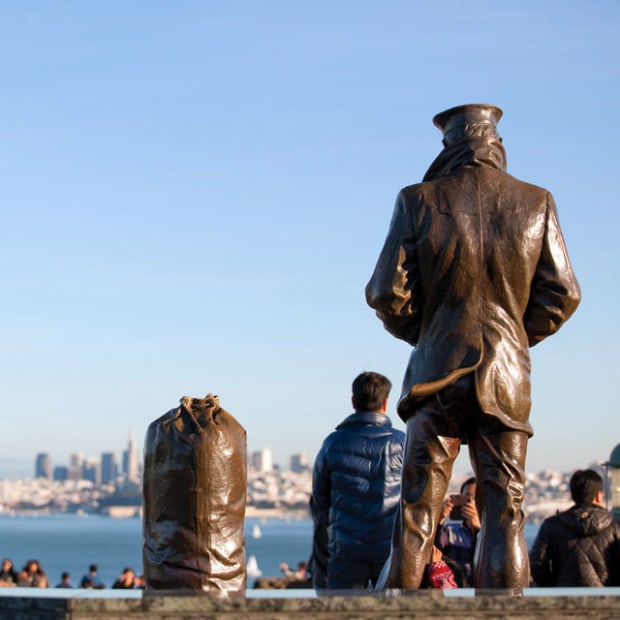 statue of the Lone Sailor looks south from Vista Point over visitors and across the bay to San Francisco, picture