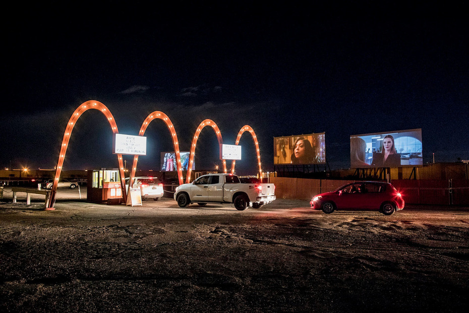 vehicles line up after sundown at entrance to West Wind Drive-In, Las Vegas, Nevada, picture