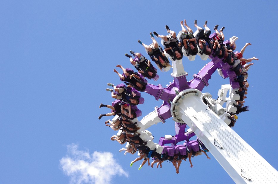 SpinCycle thrill ride filled with riders is seen from below against clear blue sky at Silverwood Theme Park in Couer d'Alene, Idaho, picture