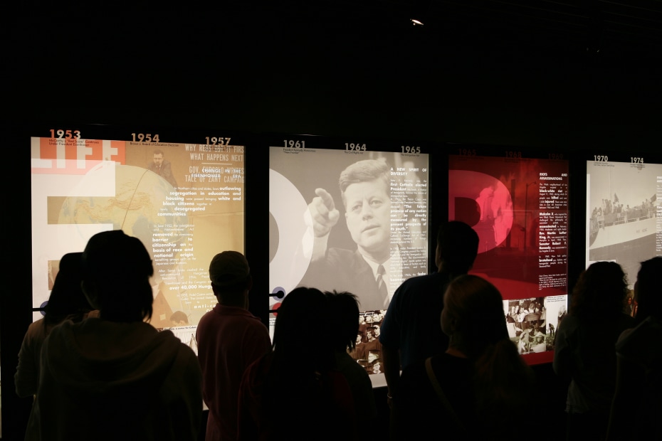 People look at an exhibit inside the Museum of Tolerance, photo
