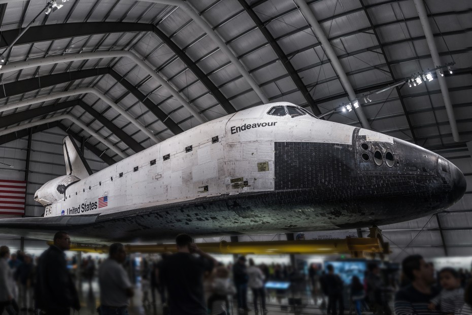 The Endeavor space shuttle hangs above the heads of visitors at the California Science Center, image