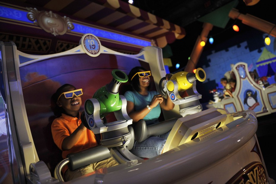 Mother and son play virtual carnival games at Toy Story Midway Mania! in Disneyland's California Adventures, image
