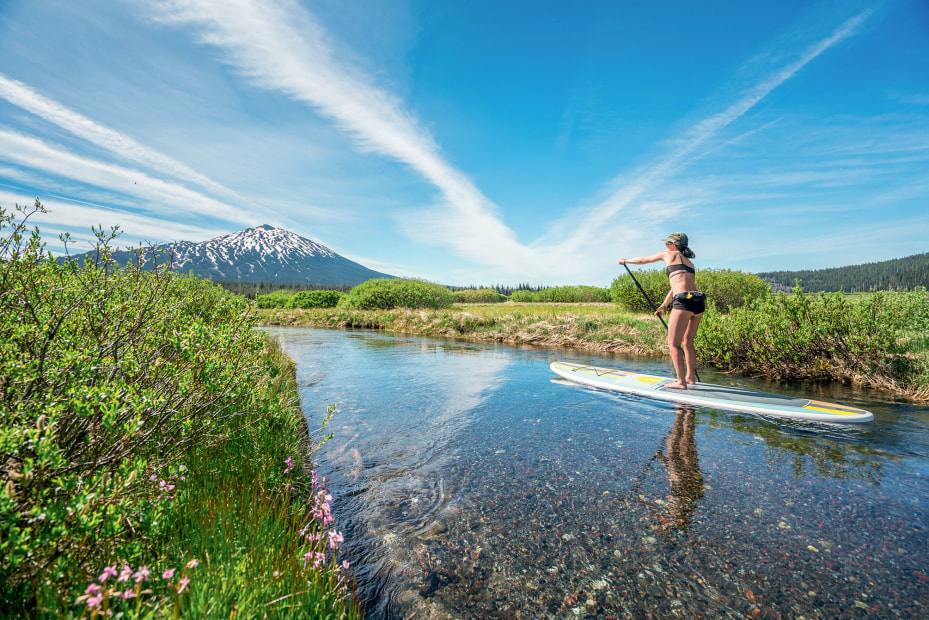 woman on stand-up paddleboard near Sparks Lake in Bend, Oregon, picture