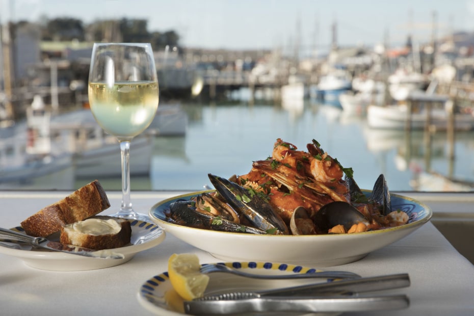 Alioto's cioppino glass of white wine with Fisherman's Wharf view in San Francisco