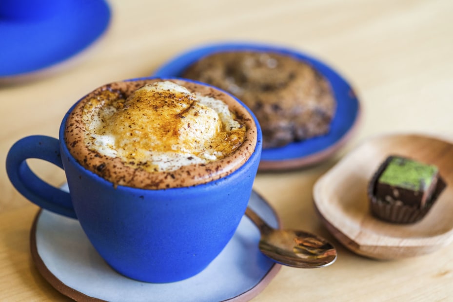 hot chocolate served in blue cup accompanied by sweet roll and chocolate treat at Cloudforest in Portland, picture