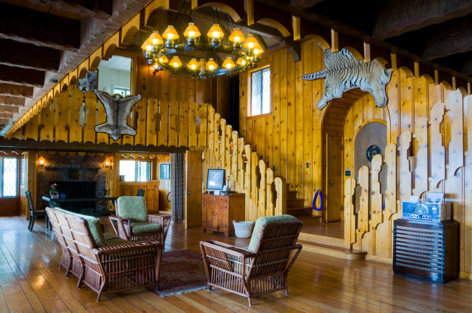 photo of the rustic interior of Thunderbird Lodge with knotty pine walls and animal skins