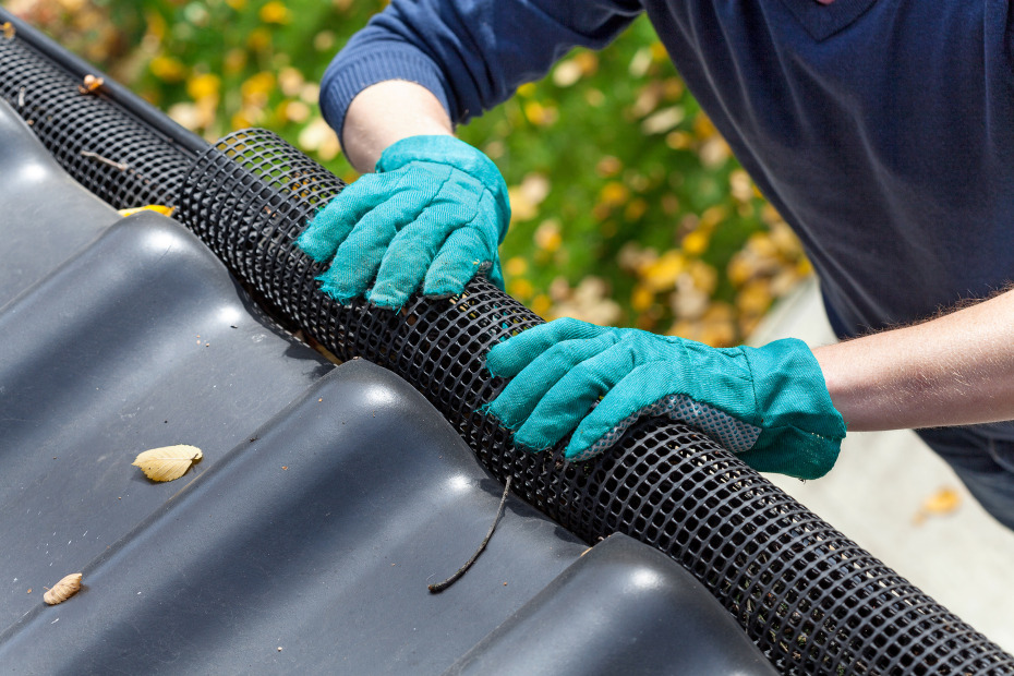 A AAA member installs a gutter screen to protect against wildfire.