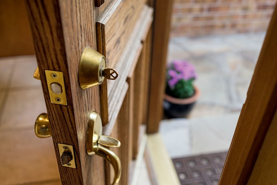 open door/side view of deadbolt lock hardware with key, picture