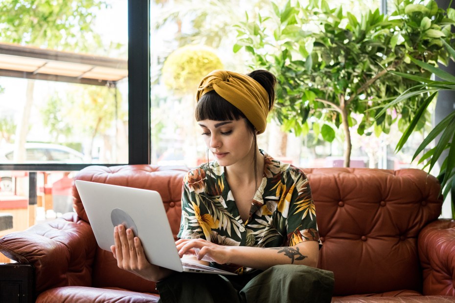 AAA Member reviews her credit report in a cafe.