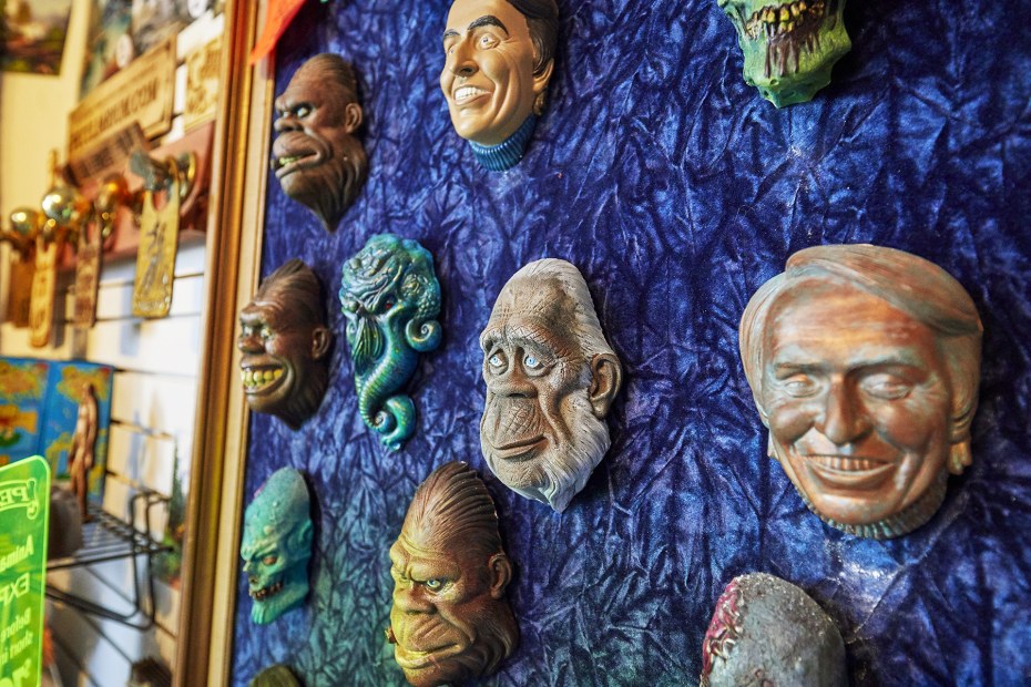 masks by artist Colin Batty grace a wall at the Freakybuttrue Peculiarium, in Portland Oregon's Northwest District