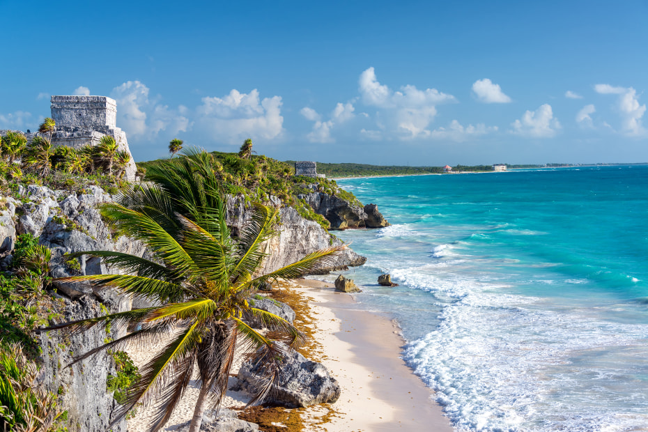 Maya ruins overlooking a white sand beach on Mexico's Riviera Maya.