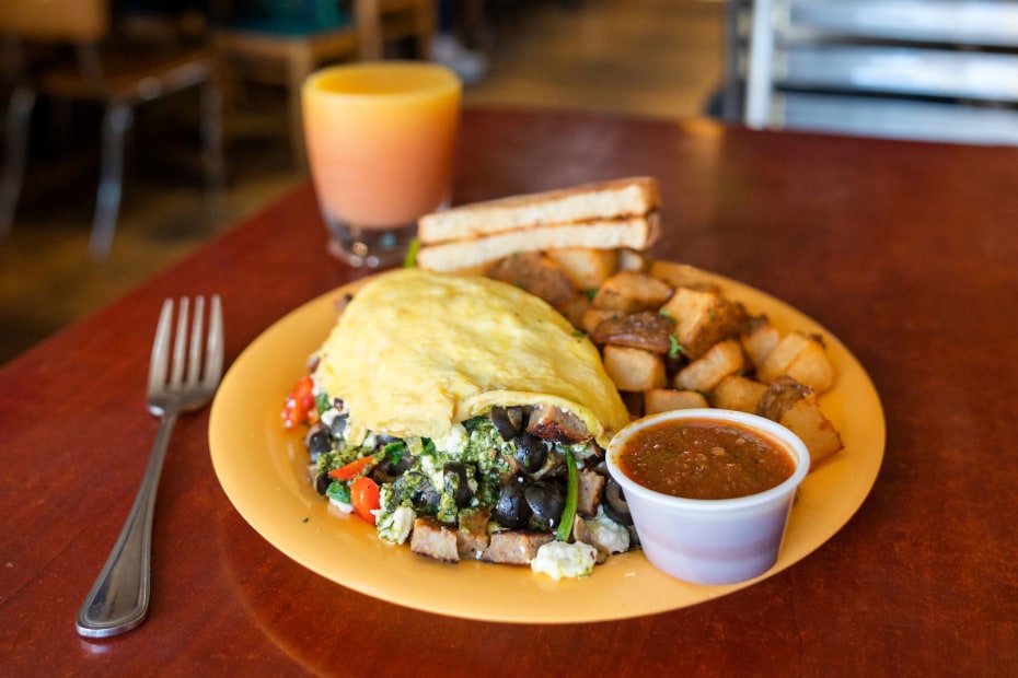 photo of a breakfast including omelette and toast in a restaurant