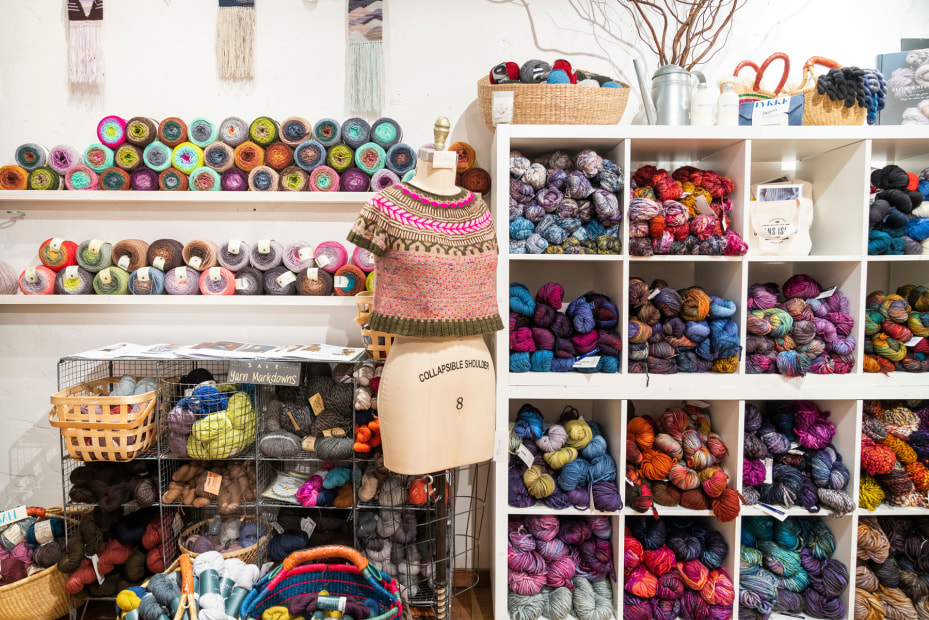 picture of colorful yarn on shelves for sale in a knitting store