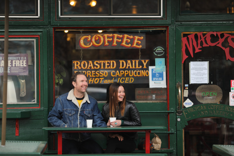 a happy couple sits outside Macy's European Coffee House & Bakery in Flagstaff, Arizona.