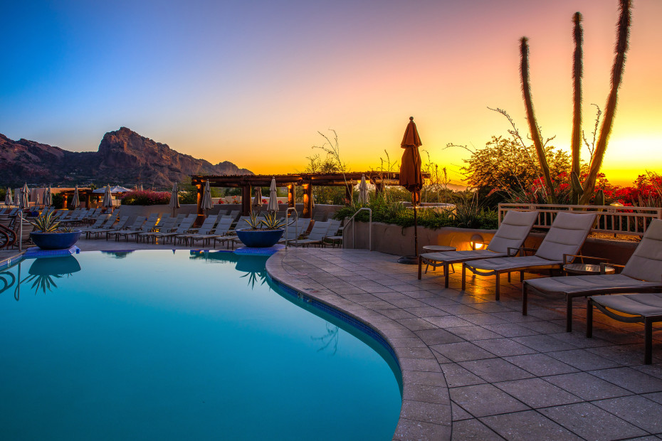 Sunset over a blue pool at a resort in Arizona.