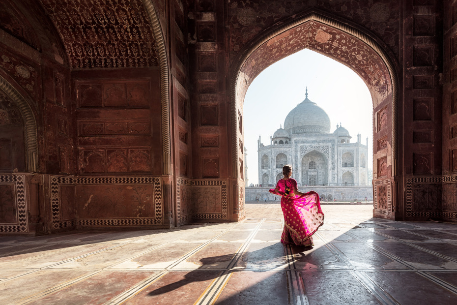 A woman in a saree at the Taj Mahal in India.