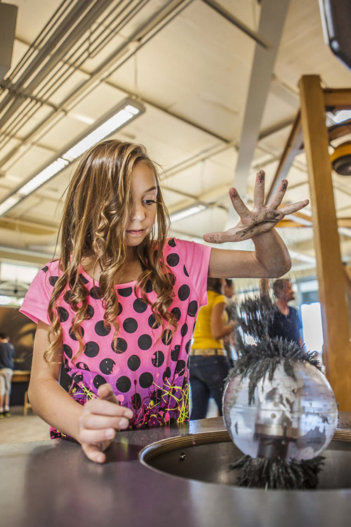 A girl plays with magnetic fragments at Da Vinci's Corner in The Discovery Museum in Reno, Nevada.