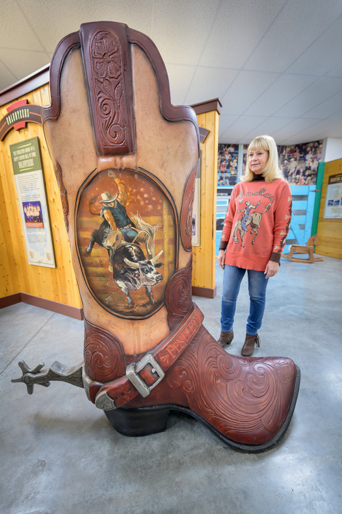 visitor admires a giant boot displayed at the The Pendleton Round-Up and Happy Canyon Hall of Fame in Pendleton, Oregon