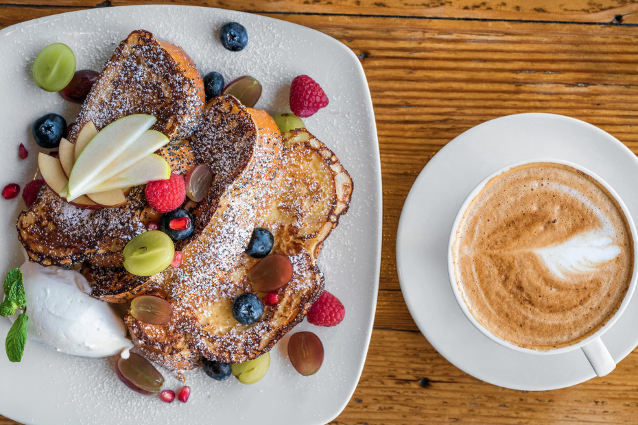 Challah French toast with fruit and citrus cream accompanied by cafe latte at Element Restaurant in Sutter Creek, California