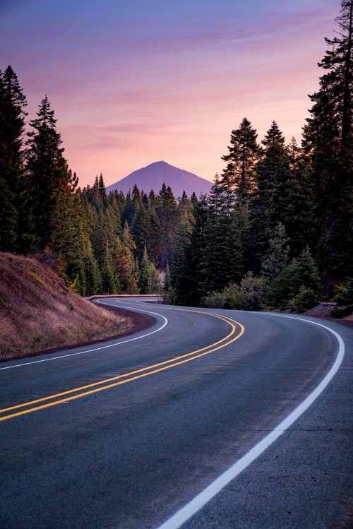 highway curves at sunset with Mount McLoughlin looming near Ashland, Oregon.