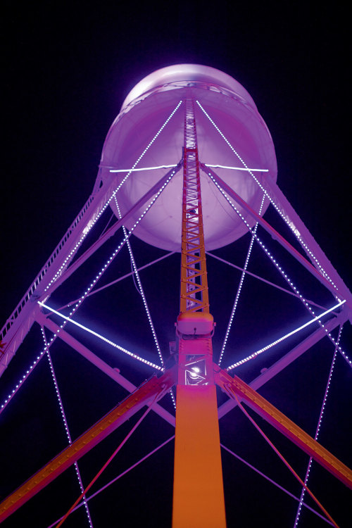 neon lights illuminate the water tower after dark in downtown Gilbert, Arizona