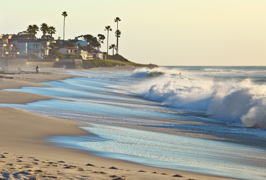 waves crash along the sand near in San Diego