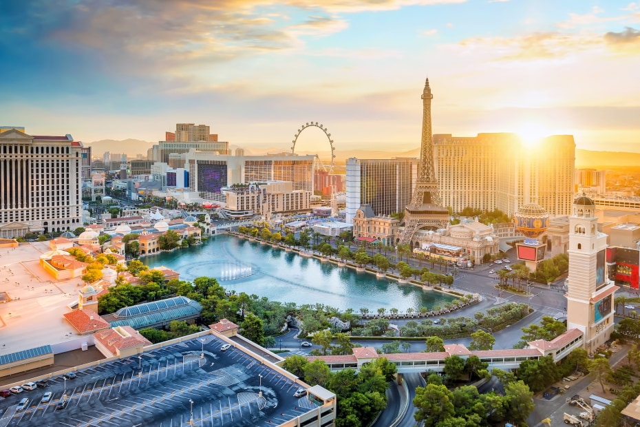 the sun rises over the Las Vegas Strip with the Bellagio fountains