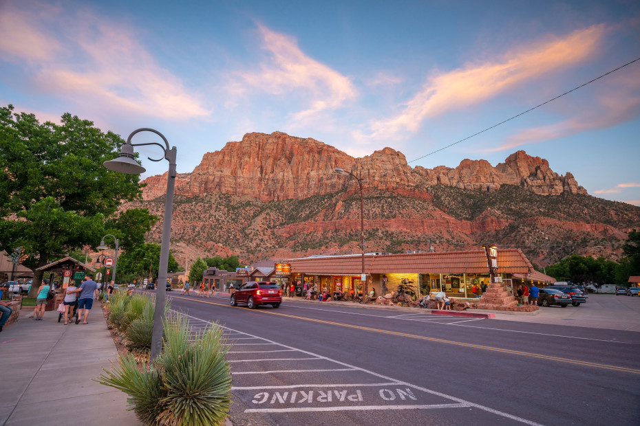 Pedestrians walk down a street in Springdale, Utah.