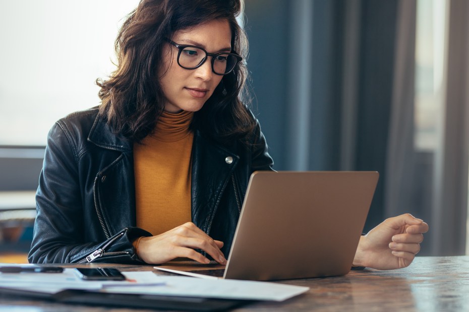 A woman works on a laptop.