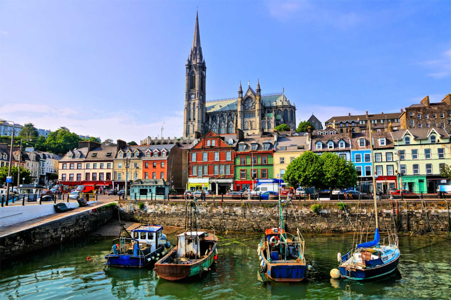 cobh harbor with boats, colorful buildings and cathedral